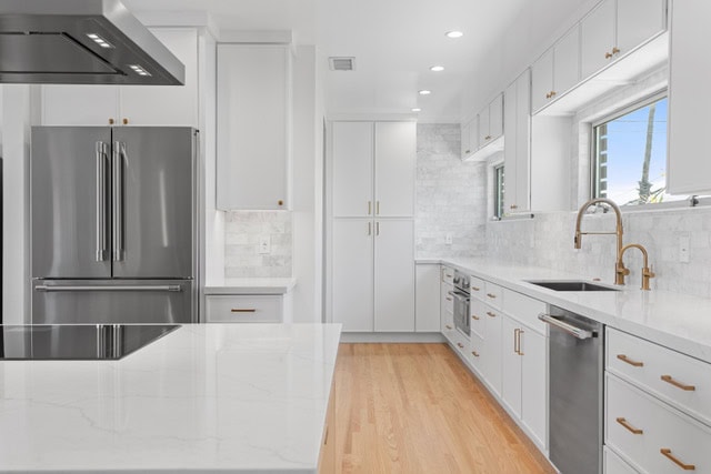 Manhattan Beach kitchen remodel with marble subway tile backsplash, stainless island hood and induction cooktop