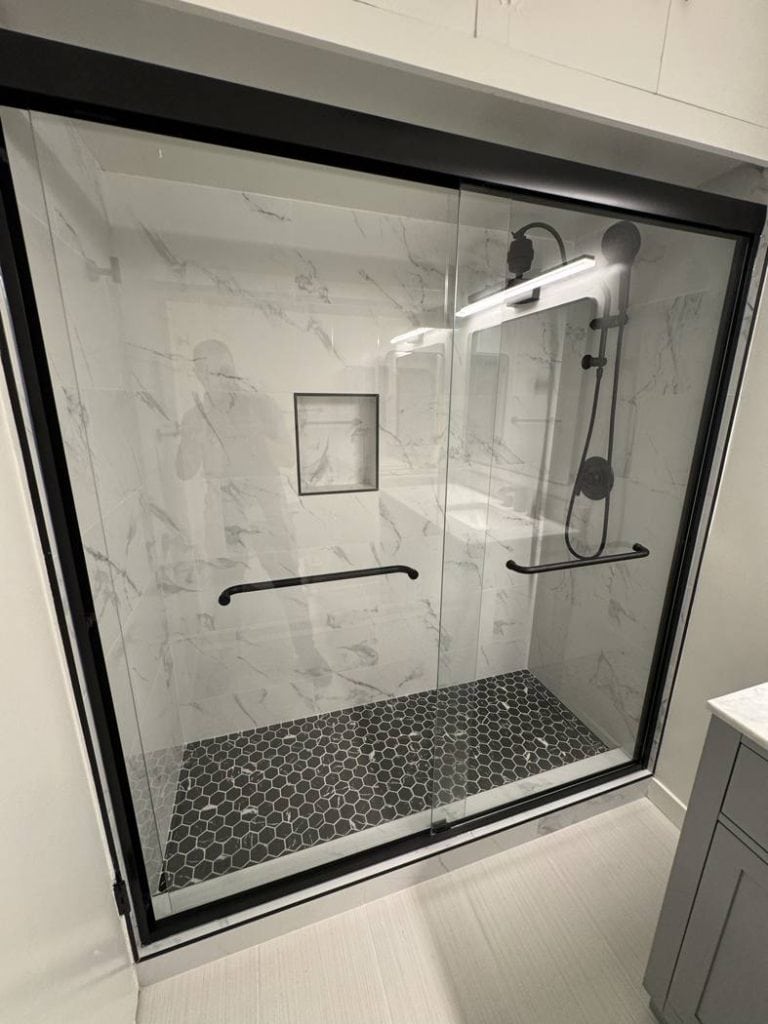 Culver City bathroom remodel - walk-in shower with marble-look tile and black fixtures