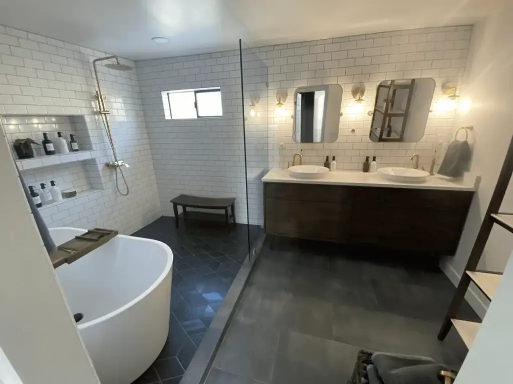 Redondo Beach bathroom remodel with freestanding tub, walk-in shower, white subway tile, brass fixtures and double vanity