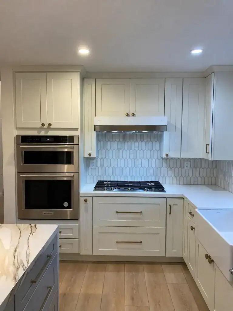 Santa Monica kitchen remodel - cream shaker cabinets, double wall ovens, gas cooktop and picket tile backsplash